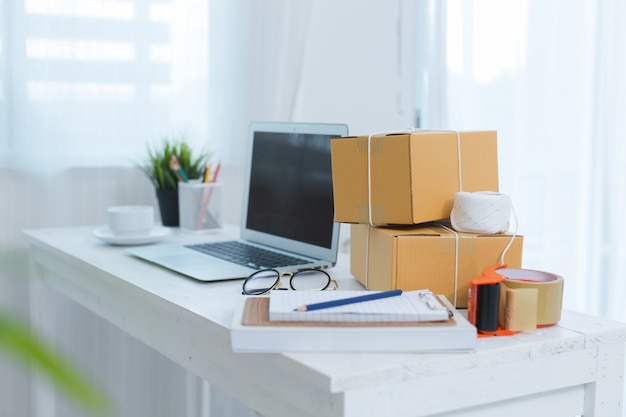 Business owner working at home office packaging Free Photo