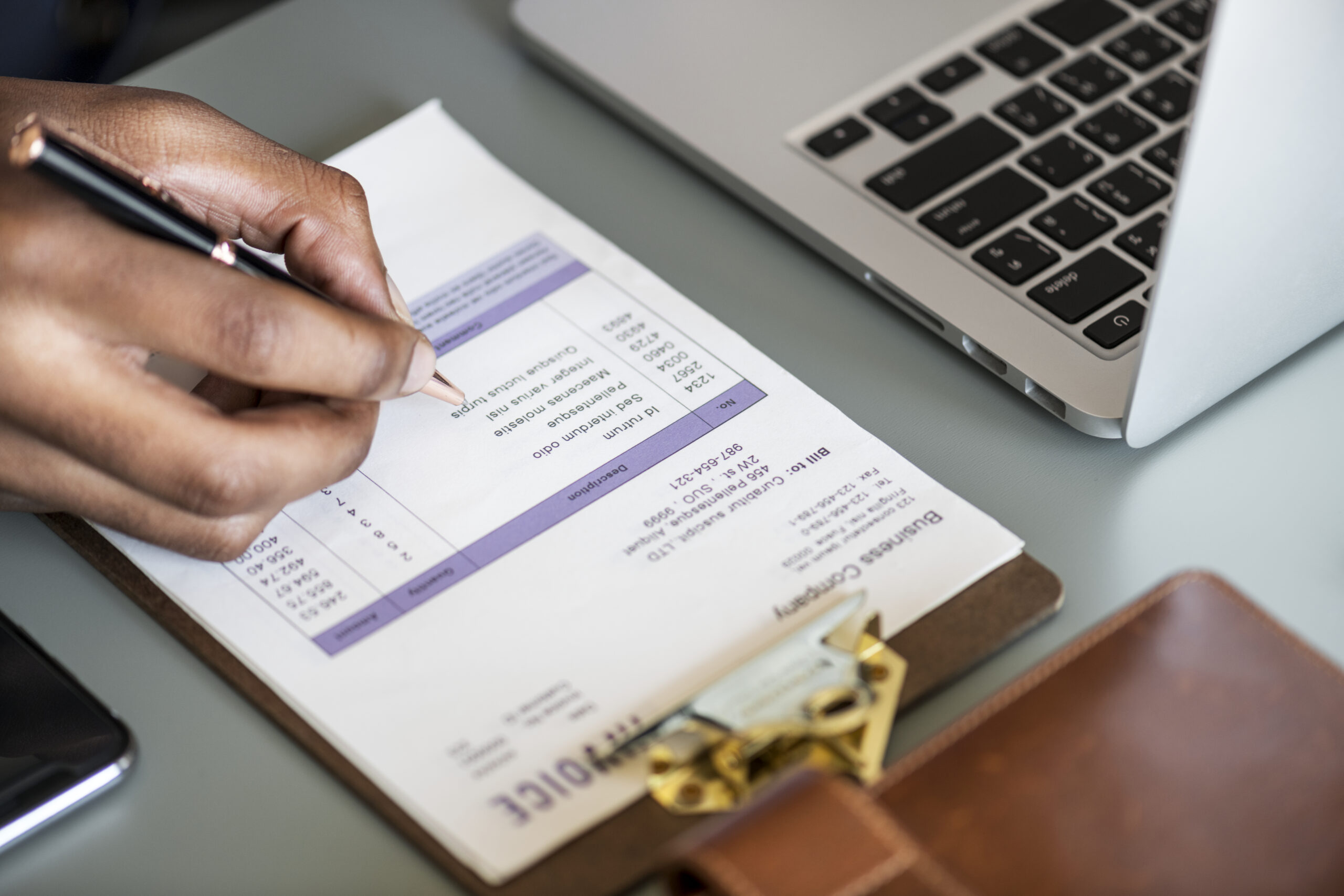 closeup business man checking tax invoice paper scaled