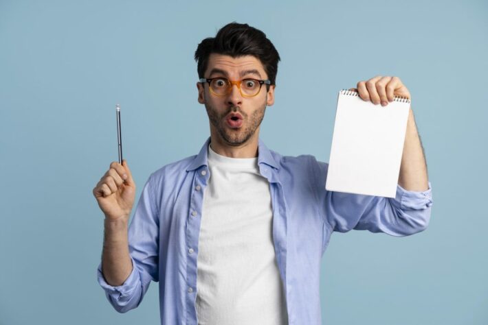 front view man with glasses having idea while holding notebook pen scaled 1