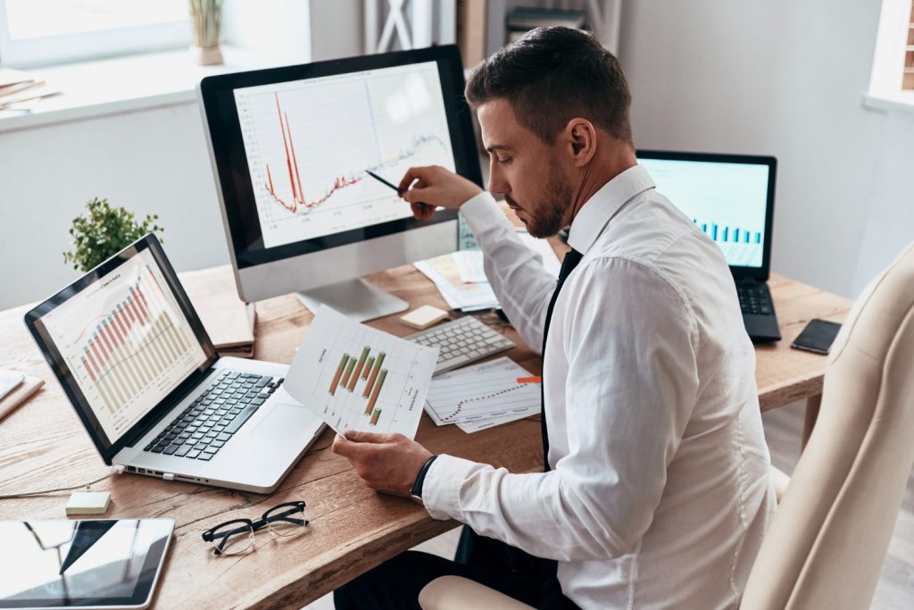 inspired work hard young businessman formalwear comparing data using computer while sitting office scaled 1