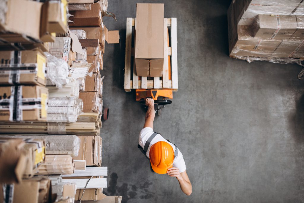 young man working warehouse with boxes scaled 1