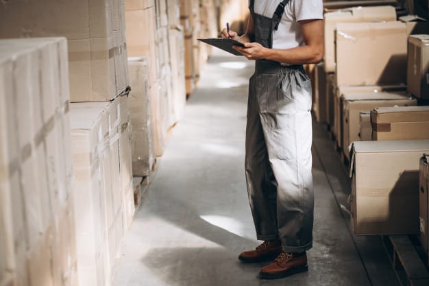 young man working warehouse with boxes 1303 16603