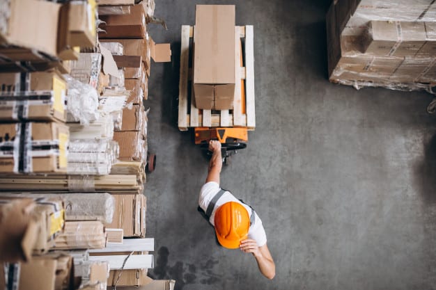 young man working warehouse with boxes 1303 16617